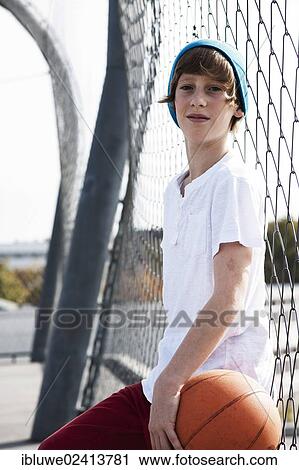 Cool boy holding a basketball View Large Photo Image Stock Image - Cool boy holding a basketball. Fotosearch