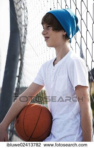 Cool boy holding a basketball View Large Photo Image Stock Image - Cool boy holding a basketball. Fotosearch