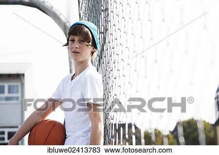 Cool boy holding a basketball View Large Photo Image Stock Image - Cool boy holding a basketball. Fotosearch