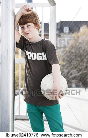 Cool boy holding a football View Large Photo Image Stock Photograph - Cool boy holding a football. Fotosearch