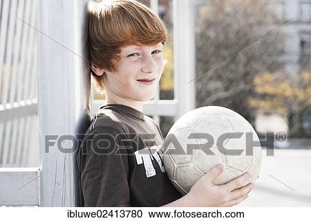 Cool boy, portrait, holding a football View Large Photo Image Stock Image - Cool boy, portrait, holding a football. Fotosearch