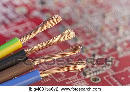 Stock Image - Copper wires in front of a red circuit board. Fotosearch