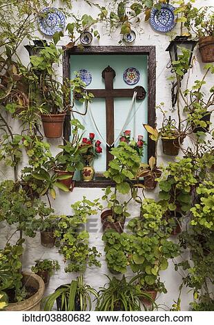 Stock Image - "Corner with many potted plants and a cross, Barrio de la Villa, Priego de Cordoba, Cordoba province, Andalusia, Spain, Europe". Fotosearch