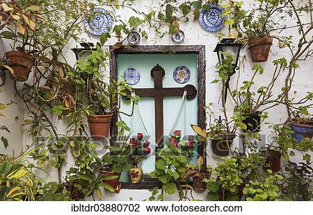 Stock Image - "Corner with many potted plants and a cross, Barrio de la Villa, Priego de Cordoba, Cordoba province, Andalusia, Spain, Europe". Fotosearch