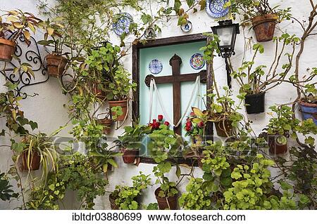 Stock Photo - "Corner with many potted plants and a cross, Barrio de la Villa, Priego de Cordoba, Cordoba province, Andalusia, Spain, Europe". Fotosearch