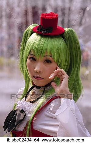 Picture - "Cosplay, Harajuku, girl with green hair dressed as a Japanese manga character in front of the Siam Paragon shopping centre, Bangkok, Thailand, Asia". Fotosearch