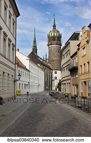 Stock Image - "Coswiner Strasse street with Schlosskirche church, Lutherstadt Wittenberg, Saxony-Anhalt, Germany, Europe". Fotosearch