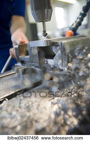 Stock Photograph - Countersink drilling with a drill press during the apprenticeship for a mechatronics engineer. Fotosearch