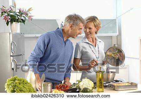 "Couple, 35-45, in love, cooking in a kitchen" View Large Photo Image Stock Image - "Couple, 35-45, in love, cooking in a kitchen". Fotosearch