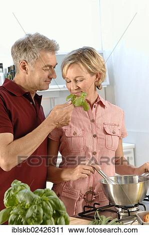 "Couple, 35-45, in love, cooking in a kitchen" View Large Photo Image Stock Image - "Couple, 35-45, in love, cooking in a kitchen". Fotosearch