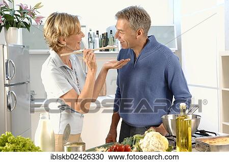 "Couple, 35-45, in love, cooking in a kitchen" View Large Photo Image Stock Image - "Couple, 35-45, in love, cooking in a kitchen". Fotosearch