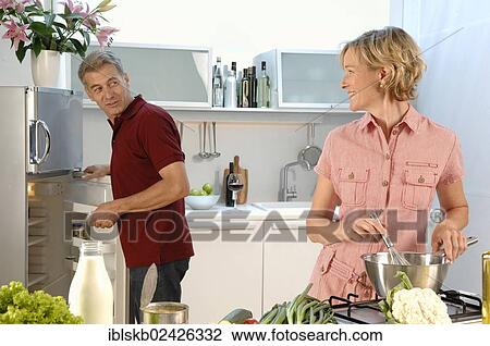 "Couple, 35-45, in love, cooking in a kitchen" View Large Photo Image Stock Image - "Couple, 35-45, in love, cooking in a kitchen". Fotosearch
