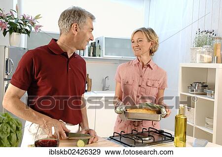"Couple, 35-45, in love, cooking in a kitchen" View Large Photo Image Stock Photo - "Couple, 35-45, in love, cooking in a kitchen". Fotosearch