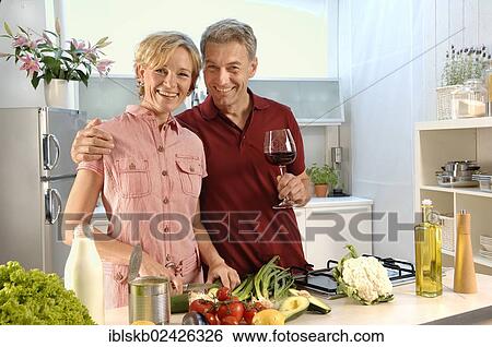"Couple, 35-45, in love, cooking in a kitchen" View Large Photo Image Stock Photograph - "Couple, 35-45, in love, cooking in a kitchen". Fotosearch