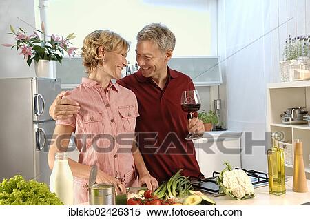 "Couple, 35-45, in love, cooking in a kitchen" View Large Photo Image Stock Photography - "Couple, 35-45, in love, cooking in a kitchen". Fotosearch