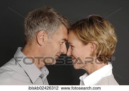 "Couple, 35-45, standing face to face" View Large Photo Image Stock Image - "Couple, 35-45, standing face to face". Fotosearch