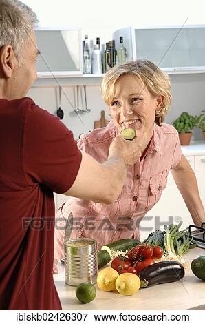 "Couple, 35 - 45 years, in love, cooking in the kitchen" View Large Photo Image Stock Photo - "Couple, 35 - 45 years, in love, cooking in the kitchen". Fotosearch