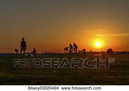 "Couple having a barbecue on Tempelhof Airfield in the evening sun in front of two passing cyclists, Berlin-Tempelhof, Tempelhofer Feld, Berlin, Berlin, Germany, Europe" View Large Photo Image Picture - "Couple having a barbecue on Tempelhof Airfield in the evening sun in front of two passing cyclists, Berlin-Tempelhof, Tempelhofer Feld, Berlin, Berlin, Germany, Europe". Fotosearch