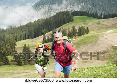 Stock Photograph - "Couple hiking, Neunerkopfle, Tannheim Valley, Tyrol, Austria, Europe". Fotosearch