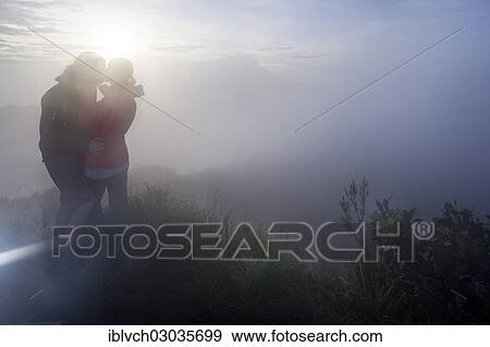 "Couple kissing in the fog on the Gunung Agung volcano, Bangli, Bali, Indonesia, Asia" View Large Photo Image Stock Photo - "Couple kissing in the fog on the Gunung Agung volcano, Bangli, Bali, Indonesia, Asia". Fotosearch