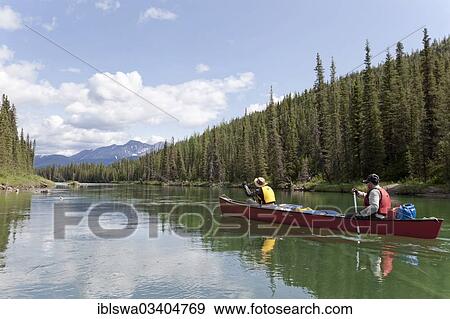 "couple, man and woman paddling a canoe, canoing, upper Liard River, Yukon Territory, Yukon Territory, Canada, North America" View Large Photo Image Stock Photo - "couple, man and woman paddling a canoe, canoing, upper Liard River, Yukon Territory, Yukon Territory, Canada, North America". Fotosearch