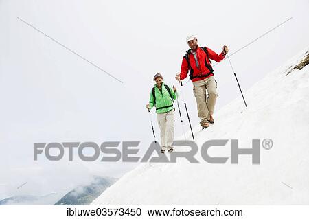 "Couple moving over a snow field during their hike to Mt. Neunerkoepfle, Neunerkopfle, Tannheim Valley, Tyrol, Austria, Europe" View Large Photo Image Stock Image - "Couple moving over a snow field during their hike to Mt. Neunerkoepfle, Neunerkopfle, Tannheim Valley, Tyrol, Austria, Europe". Fotosearch