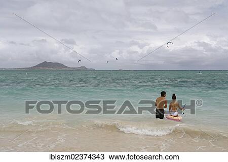 "Couple on the sandy beach of Kailua, O'ahu, Hawaii, USA" View Large Photo Image Stock Image - "Couple on the sandy beach of Kailua, O'ahu, Hawaii, USA". Fotosearch