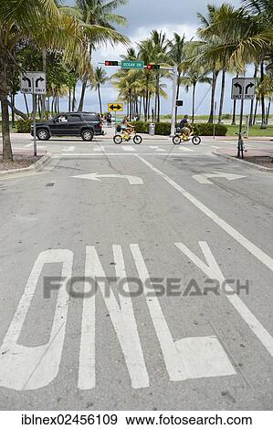 "Couple riding electric bicycles, Ocean Drive, South Beach, Miami, Florida, USA" View Large Photo Image Stock Photo - "Couple riding electric bicycles, Ocean Drive, South Beach, Miami, Florida, USA". Fotosearch