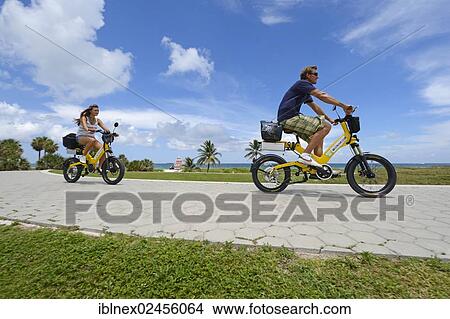 "Couple riding electric bicycles, South Pointe Park, South Beach, Miami, Florida, USA" View Large Photo Image Picture - "Couple riding electric bicycles, South Pointe Park, South Beach, Miami, Florida, USA". Fotosearch