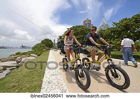 "Couple riding electric bicycles, South Pointe Park, South Beach, Miami, Florida, USA" View Large Photo Image Stock Image - "Couple riding electric bicycles, South Pointe Park, South Beach, Miami, Florida, USA". Fotosearch
