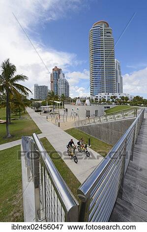 Stock Photo - "Couple riding electric bicycles, South Pointe Park, South Beach, Miami, Florida, USA". Fotosearch