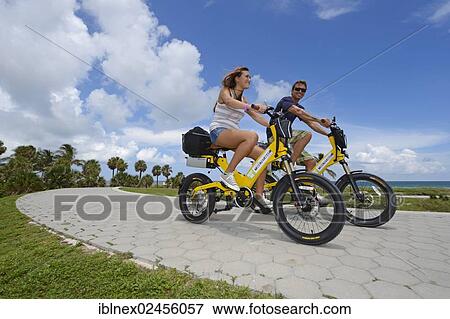 "Couple riding electric bicycles, South Pointe Park, South Beach, Miami, Florida, USA" View Large Photo Image Stock Photo - "Couple riding electric bicycles, South Pointe Park, South Beach, Miami, Florida, USA". Fotosearch