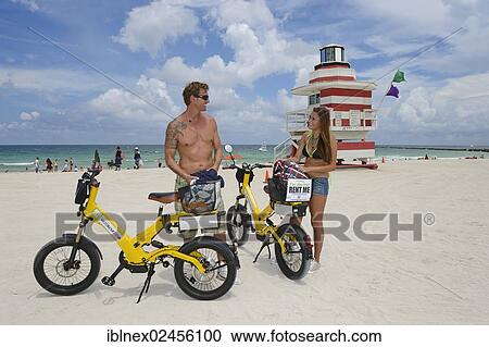 "Couple riding electric bicycles, Watchtower, The Jetty, Miami Rescue Tower, South Beach, Miami, Florida, USA" View Large Photo Image Stock Image - "Couple riding electric bicycles, Watchtower, The Jetty, Miami Rescue Tower, South Beach, Miami, Florida, USA". Fotosearch