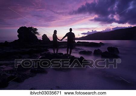 "Couple standing on the beach after sunset, holding each other's hands, Kuta Lombok, Lombok island, Nusa Tenggara Barat Province, Indonesia, Asia" View Large Photo Image Stock Image - "Couple standing on the beach after sunset, holding each other's hands, Kuta Lombok, Lombok island, Nusa Tenggara Barat Province, Indonesia, Asia". Fotosearch