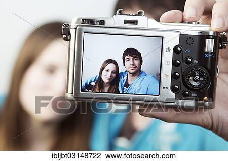 "Couple taking pictures of themselves, self-portrait on the display of the camera, Germany, Europe" View Large Photo Image Stock Image - "Couple taking pictures of themselves, self-portrait on the display of the camera, Germany, Europe". Fotosearch