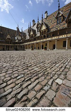 "Courtyard of the Hotel-Dieu, a former hospital, 1422, Beaune, Departement Cote-d? ÇÖOr, Region Burgundy, France, Europe" View Large Photo Image Stock Photograph - "Courtyard of the Hotel-Dieu, a former hospital, 1422, Beaune, Departement Cote-d? ÇÖOr, Region Burgundy, France, Europe". Fotosearch