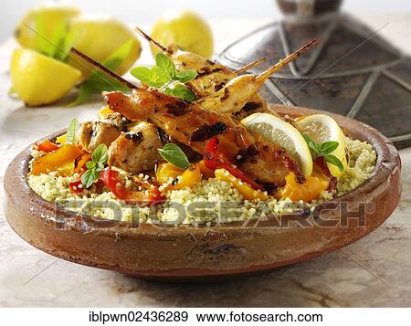 Couscous with Mediterranean roast vegetables and chicken kebabs View Large Photo Image Stock Photo - Couscous with Mediterranean roast vegetables and chicken kebabs. Fotosearch