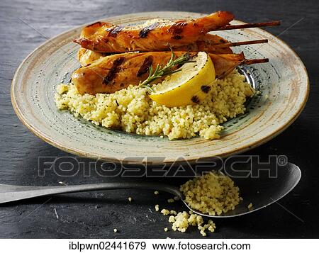 Couscous with Mediterranean roast vegetables and chicken kebabs View Large Photo Image Stock Photo - Couscous with Mediterranean roast vegetables and chicken kebabs. Fotosearch