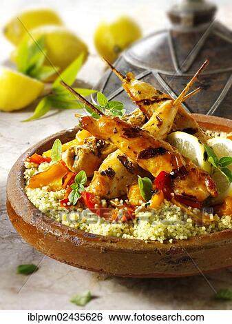 Couscous with Mediterranean roast vegetables and chicken kebabs View Large Photo Image Stock Photograph - Couscous with Mediterranean roast vegetables and chicken kebabs. Fotosearch