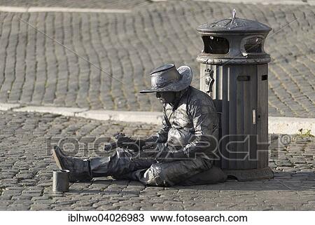 Stock Image - "Cowboy, actor with guns sitting on the Via della Conciliazone, XIV rione Borgo, Rome, Lazio, Italy, Europe". Fotosearch