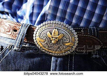Stock Photo - "Cowboy belt buckle with the inscription &quot; Cowboy till death&quot;, Saskatchewan Province, Canada, North America". Fotosearch