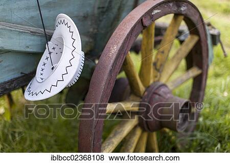 "Cowboy hat hanging on a horse trailer, wooden spoked wheel" View Large Photo Image Stock Photo - "Cowboy hat hanging on a horse trailer, wooden spoked wheel". Fotosearch