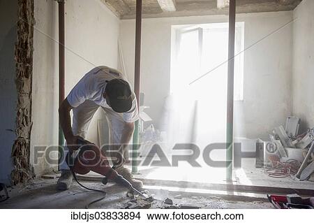 Craftsman during the substantial refurbishment of a building View Large Photo Image Picture - Craftsman during the substantial refurbishment of a building. Fotosearch