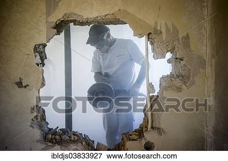 Craftsman during the substantial refurbishment of a building View Large Photo Image Stock Photo - Craftsman during the substantial refurbishment of a building. Fotosearch