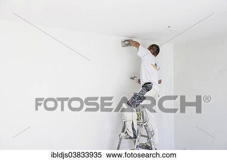 Craftsman plastering the wall of a flat View Large Photo Image Stock Photography - Craftsman plastering the wall of a flat. Fotosearch
