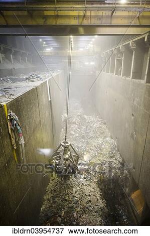"Crane transporting waste to the incinerators at a waste incineration plant, Essen-Karnap, North Rhine-Westphalia, Germany, Europe" View Large Photo Image Stock Photo - "Crane transporting waste to the incinerators at a waste incineration plant, Essen-Karnap, North Rhine-Westphalia, Germany, Europe". Fotosearch