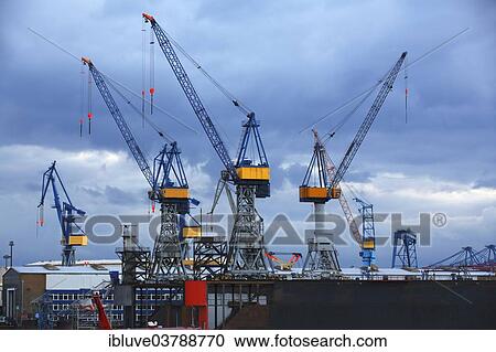 "Cranes on a dock of the Blohm + Voss shipyard in the evening light, port of Hamburg, Hamburg, Germany, Europe" View Large Photo Image Stock Image - "Cranes on a dock of the Blohm + Voss shipyard in the evening light, port of Hamburg, Hamburg, Germany, Europe". Fotosearch