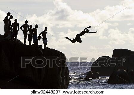 "Creole teenagers jumping from rocks, silhouettes, Mahe, Seychelles, Africa, Indian Ocean, Africa" View Large Photo Image Stock Photo - "Creole teenagers jumping from rocks, silhouettes, Mahe, Seychelles, Africa, Indian Ocean, Africa". Fotosearch