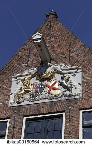 Picture - "Crest with a lion and a horse on a historic warehouse of the Dutch West India Company, Walcheren, Vlissingen, Walcheren, Zeeland province, The Netherlands, Europe". Fotosearch