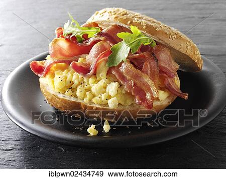 Crispy bacon and scrambled eggs on a bagel View Large Photo Image Stock Photo - Crispy bacon and scrambled eggs on a bagel. Fotosearch